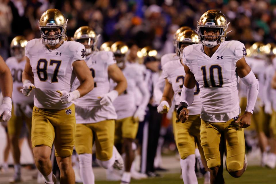 Notre Dame players take to the field prior to their game against Virginia at Scott Stadium on Nov. 13, 2021.