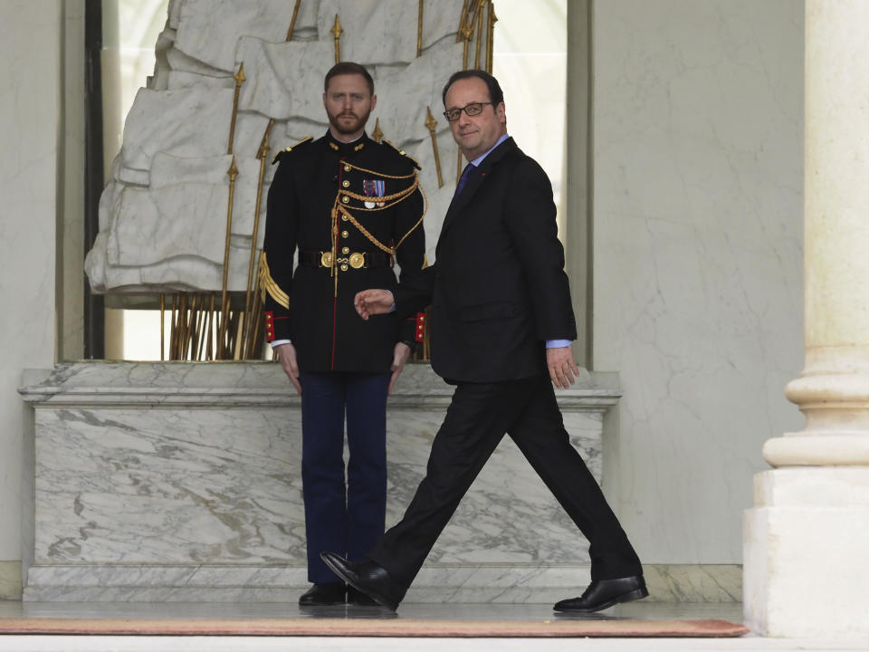 France's President Francois Hollande walks on the lobby of the Elysee Palace after the weekly cabinet meeting, in Paris, Wednesday, March 22, 2017. (AP Photo/Thibault Camus)
