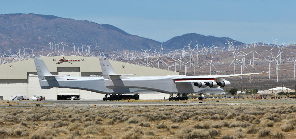 The Stratolaunch aircraft, a six-engine jet with the world's longest wingspan, is seen at Mojave Air and Space Port in Mojave, Calif., Thursday, April 29, 2021. The gigantic plane named Roc, a twin-fuselage aircraft, has a wingspan of 385 feet. It was developed by Microsoft co-founder Paul G. Allen, who died just months before it flew for the first time in April 2019. Allen intended to use it as a carrier aircraft for space launches. New owners initially plan to use it as a carrier aircraft for launches of reusable hypersonic flight research vehicles. (AP Photo/Matt Hartman)