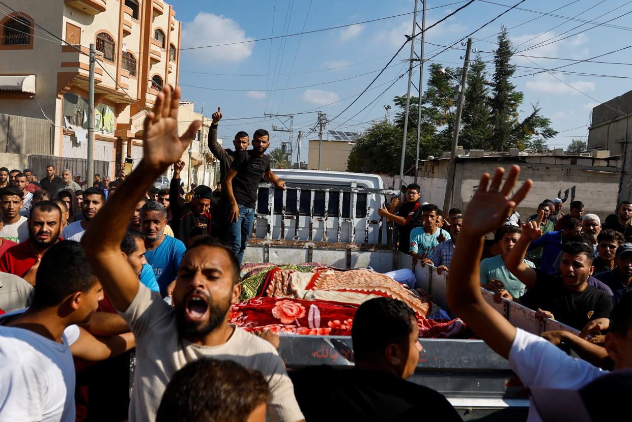 People transport the bodies of Palestinians from the Samour family, who were killed in Israeli strikes on their house (REUTERS)