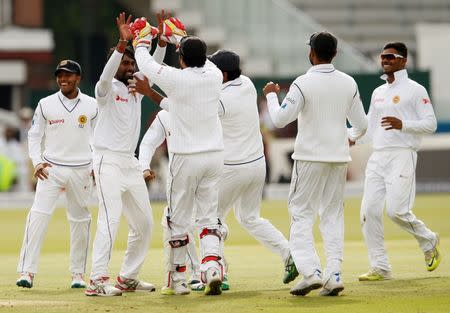 Britain Cricket - England v Sri Lanka - Third Test - Lord’s - 11/6/16 Sri Lanka’s Nuwan Pradeep (2nd L) celebrates with team mates after bowling out England’s James Vince (not pictured) Action Images via Reuters / Andrew Boyers