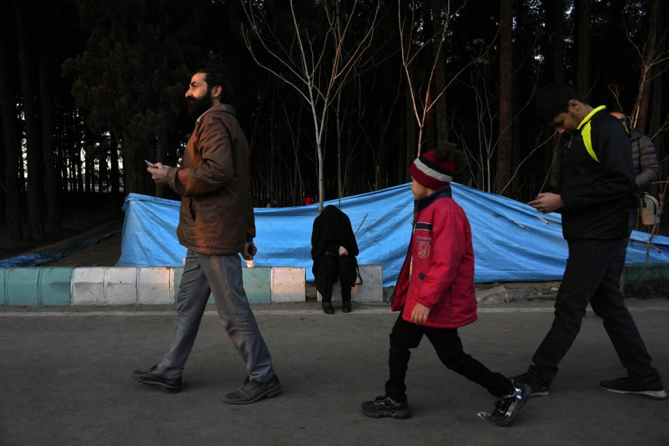 A woman weeps at the scene of Wednesday's bomb explosion in the city of Kerman about 510 miles (820 kms) southeast of the capital Tehran, Iran, Thursday, Jan. 4, 2024. Investigators believe suicide bombers likely carried out an attack on a commemoration for an Iranian general slain in a 2020 U.S. drone strike, state media reported Thursday, as Iran grappled with its worst mass-casualty attack in decades and as the wider Mideast remains on edge. (AP Photo/Vahid Salemi)