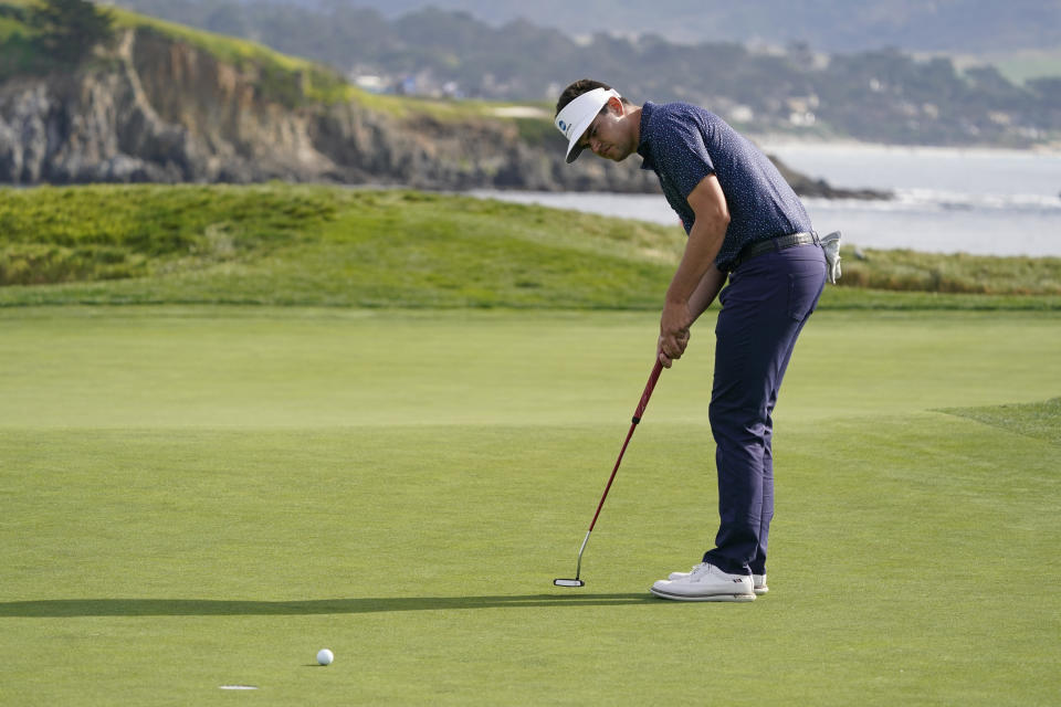 Beau Hossler makes a birdie putt on the 17th green of the Pebble Beach Golf Links during the third round of the AT&T Pebble Beach Pro-Am golf tournament in Pebble Beach, Calif., Saturday, Feb. 5, 2022. (AP Photo/Eric Risberg)