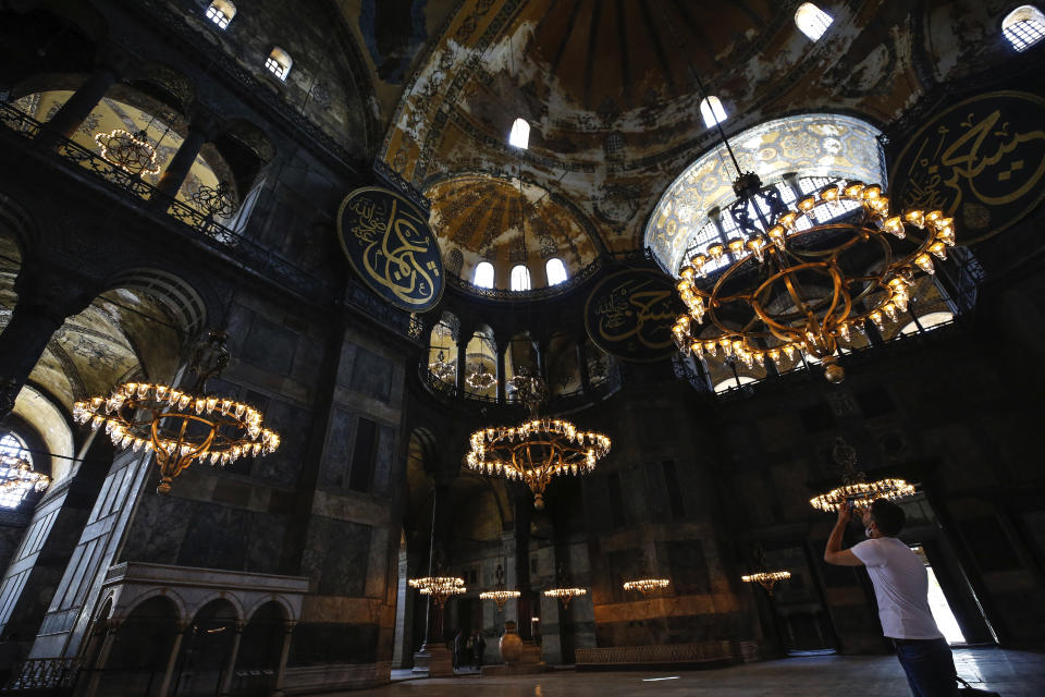 People visit the Byzantine-era Hagia Sophia, one of Istanbul's main tourist attractions in the historic Sultanahmet district of Istanbul, Thursday, June 25, 2020. The 6th-century building is now at the center of a heated debate between conservative groups who want it to be reconverted into a mosque and those who believe the World Heritage site should remain a museum. (AP Photo/Emrah Gurel)