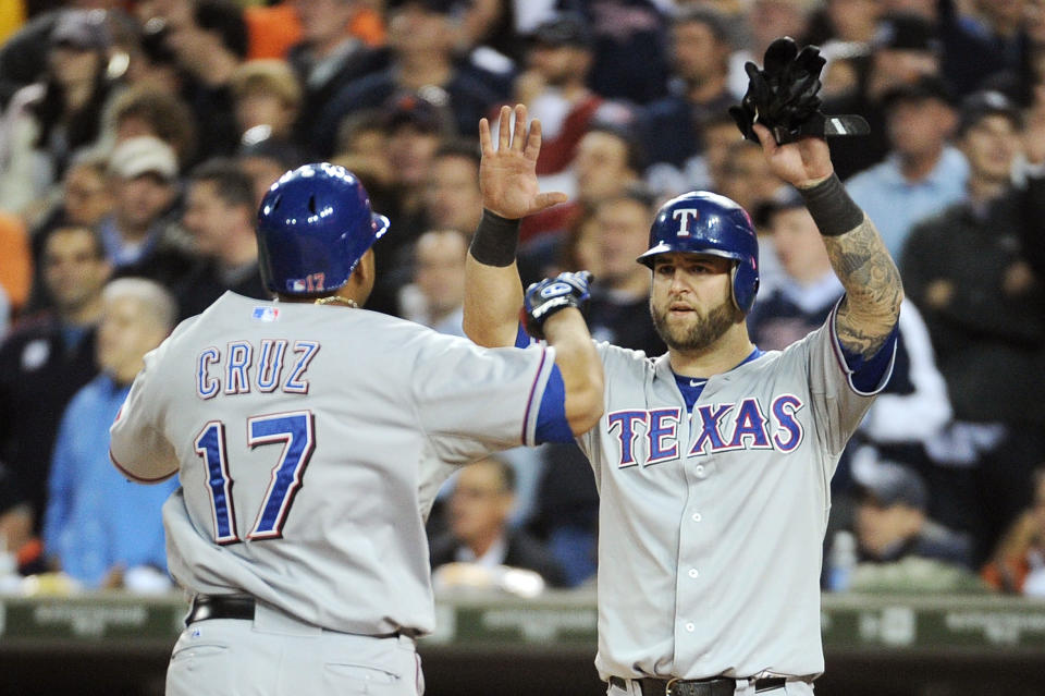 DETROIT, MI - OCTOBER 13: Nelson Cruz #17 and Mike Napoli #25 of the Texas Rangers celebrate after Cruz's two-run home run in the eighth inning of Game Five of the American League Championship Series against the Detroit Tigers at Comerica Park on October 13, 2011 in Detroit, Michigan. (Photo by Harry How/Getty Images)