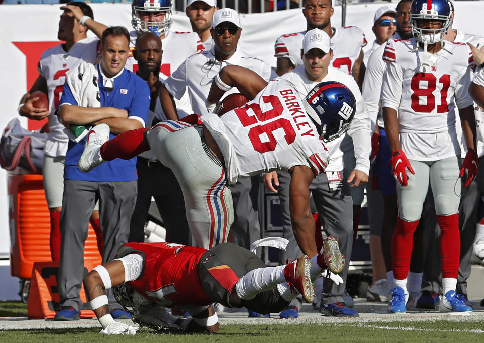 New York Giants running back Saquon Barkley (26) gets hit by Tampa Bay Buccaneers safety Mike Edwards (34) during the first half of an NFL football game Sunday, Sept. 22, 2019, in Tampa, Fla. Barkley left the game. (AP Photo/Mark LoMoglio)