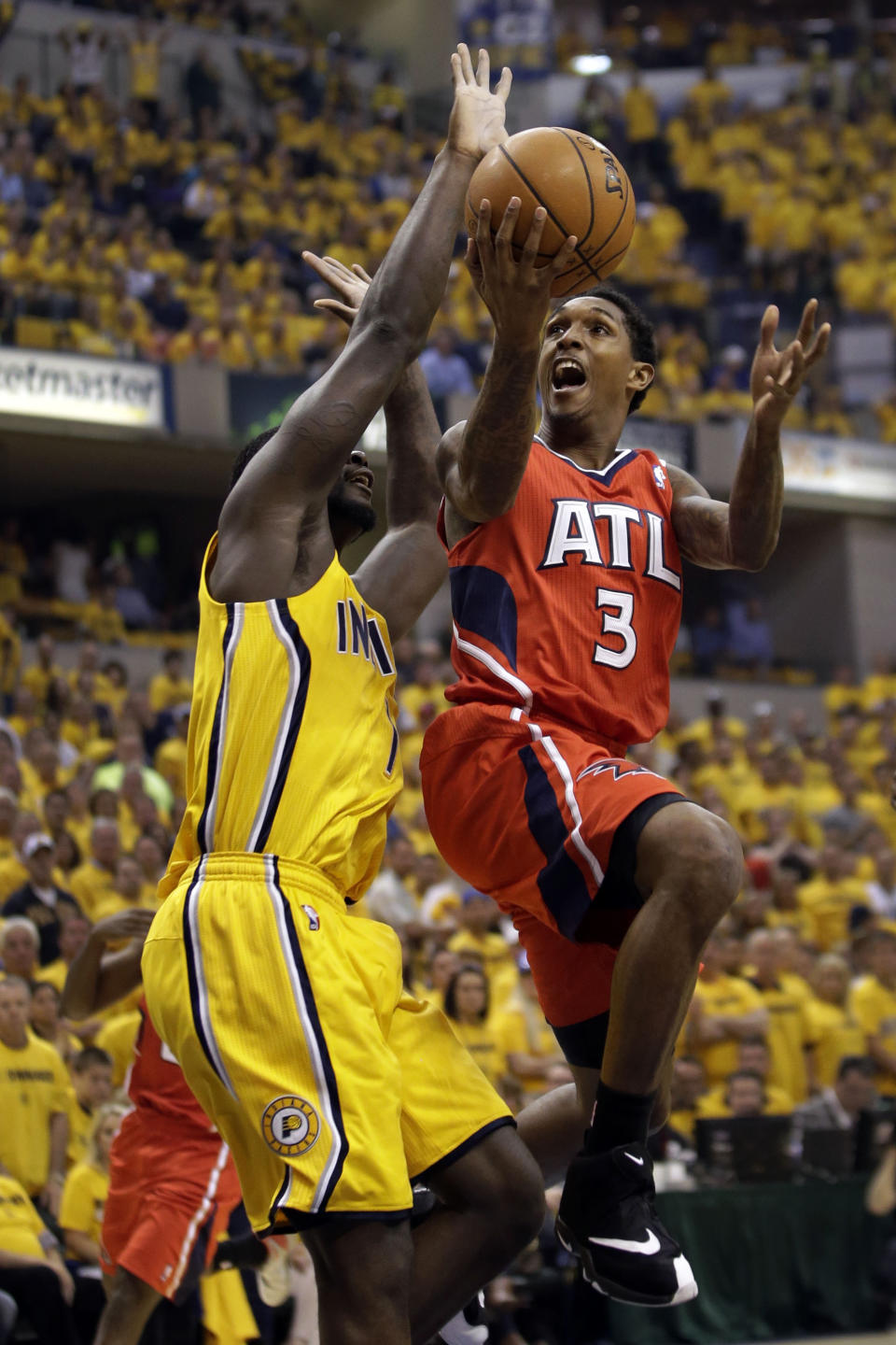 Atlanta Hawks guard Louis Williams, right, shoots around the defense of Indiana Pacers guard Lance Stephenson during Game 7 of a first-round NBA basketball playoff series in Indianapolis, Saturday, May 3, 2014. (AP Photo/AJ Mast)