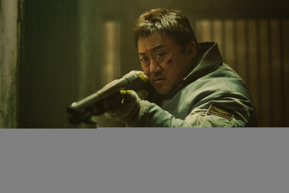 a man (don lee) aims a shotgun