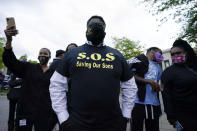 People gather outside the municipal building after at least one Pasquotank County Sheriff's deputy shot and killed a Black man, Andrew Brown Jr., while executing a search warrant, the sheriff's office said, Wednesday, April 21, 2021, in Elizabeth City, N.C. The deputy was wearing an active body camera at the time of the shooting, said Sheriff Tommy Wooten II, who declined to say how many shots the deputy fired or release any other details, citing a pending review by the State Bureau of Investigation. (AP Photo/Gerry Broome)