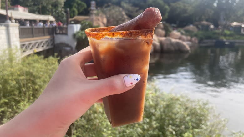 A red drink with sausage