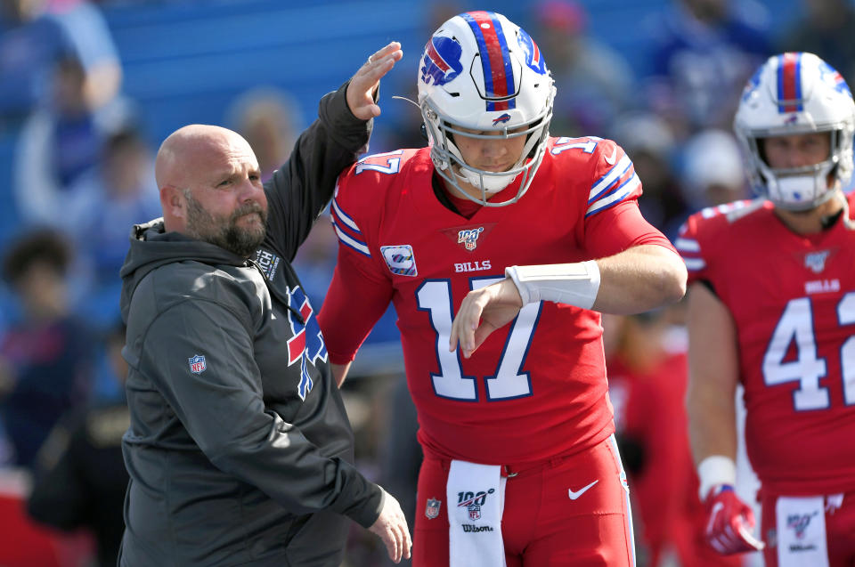 FILE - In this Oct. 20, 2019, file photo, Buffalo Bills offensive coordinator Brian Daboll, left, encourages quarterback Josh Allen as he warms up before an NFL football game Miami Dolphins, Sunday, Oct. 20, 2019, in Orchard Park, N.Y. Allen and Daboll are overseeing an offensive renaissance in Buffalo in which the suddenly pass-happy Bills are among the NFL's most explosive teams three weeks into the season. (AP Photo/Adrian Kraus, File)