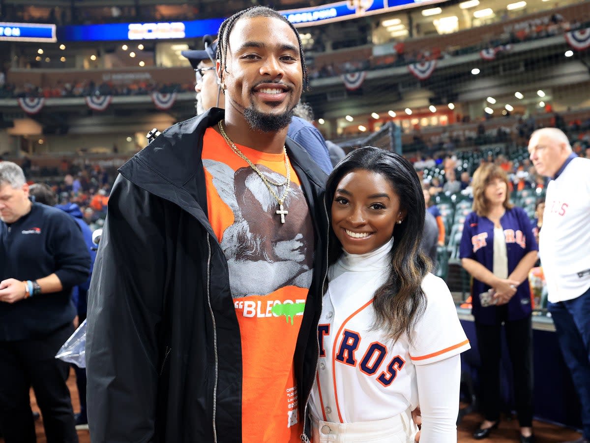 Simone Biles and Jonathan Owens pose on the field prior to Game One of the 2022 World Series between the Philadelphia Phillies and the Houston Astros at Minute Maid Park on 28 October 2022 in Houston, Texas (Getty Images)