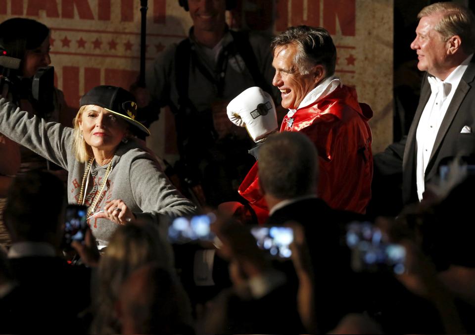 Mitt Romney is lead to the ring by his wife Ann Romney before he fights five-time heavyweight champion Evander Holyfield during a boxing match in Salt Lake City, Utah