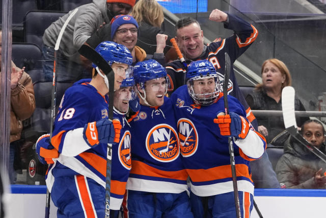 New York Islanders' Pierre Engvall (18), Ryan Pulock (6) and Alexander Romanov (28) celebrate with Cal Clutterbuck after Clutterbuck scored a goal during the second period of an NHL hockey game against the Toronto Maple Leafs Tuesday, March 21, 2023, in Elmont, N.Y. (AP Photo/Frank Franklin II)