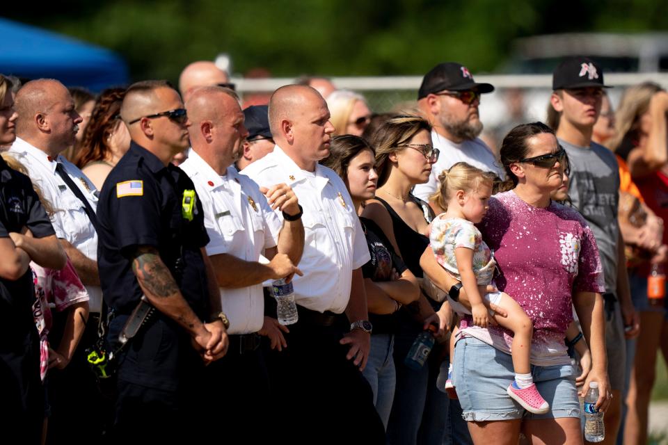 Community members and first responders gather in New Richmond for a memorial service held by the New Richmond Youth Sports Association for Clayton Doerman, 7, his brothers Hunter, 4, and Chase, 3, on Sunday. The Doerman brothers were killed at their home in Monroe Township, their father, Chad Doerman, has been charged in their shootings.