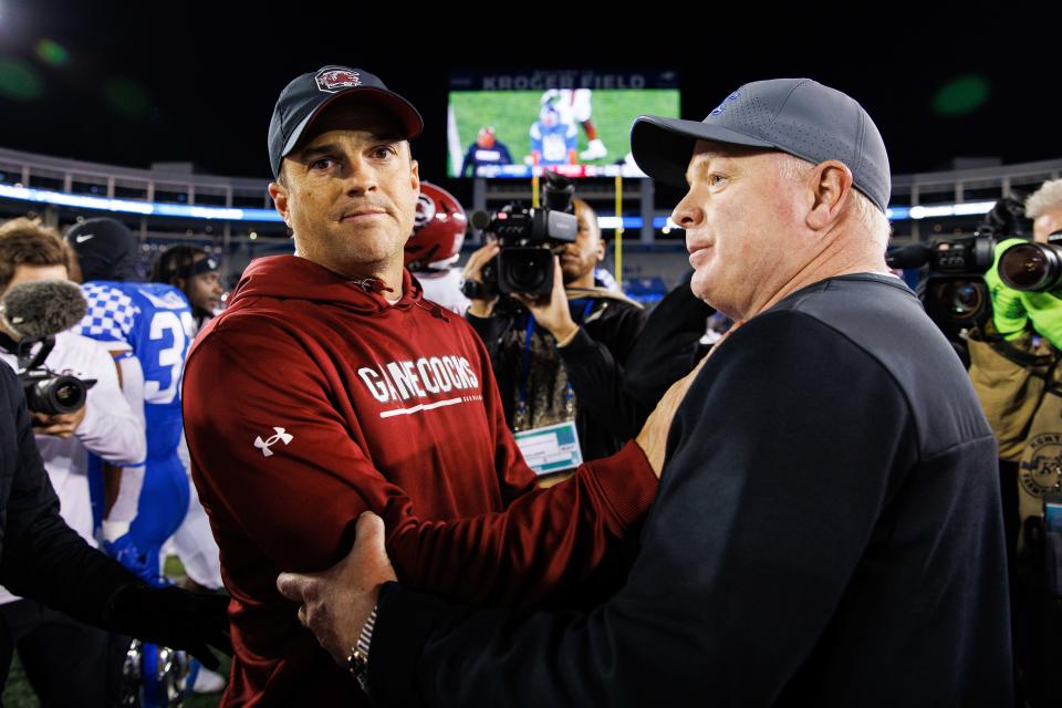 South Carolina coach Shane Beamer and UK's Mark Stoops meet on the field after a 2022 game in Lexington.