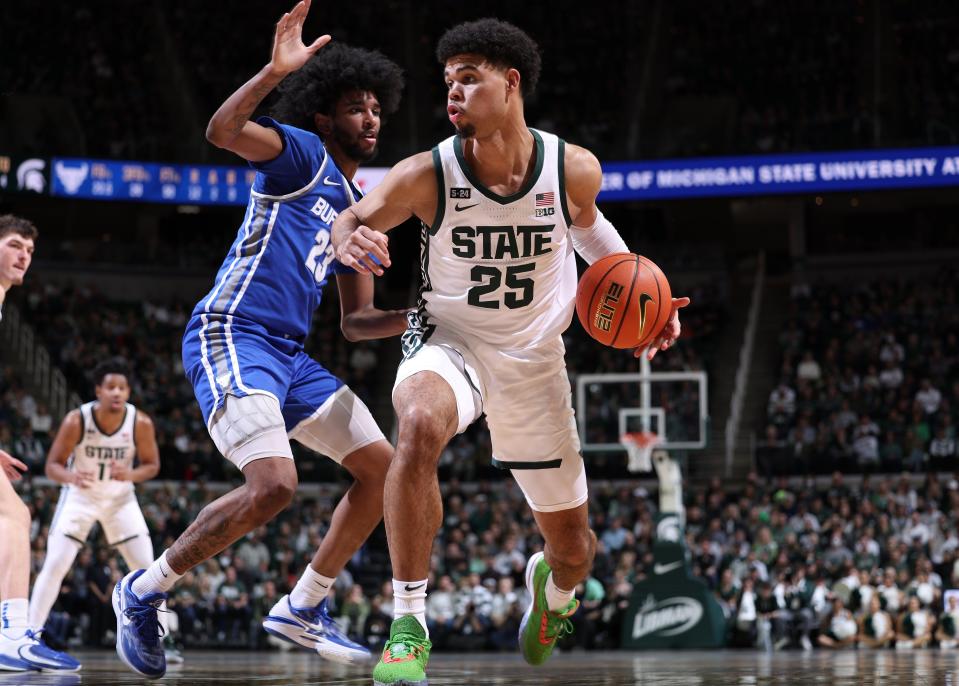 Malik Hall of the Michigan State Spartans handles the ball while defended by Isaiah Adams of the Buffalo Bulls during the first half at Breslin Center in East Lansing on Friday, Dec. 30, 2022.