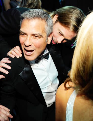 <p>Kevin Mazur/WireImage</p> Brad Pitt and George Clooney