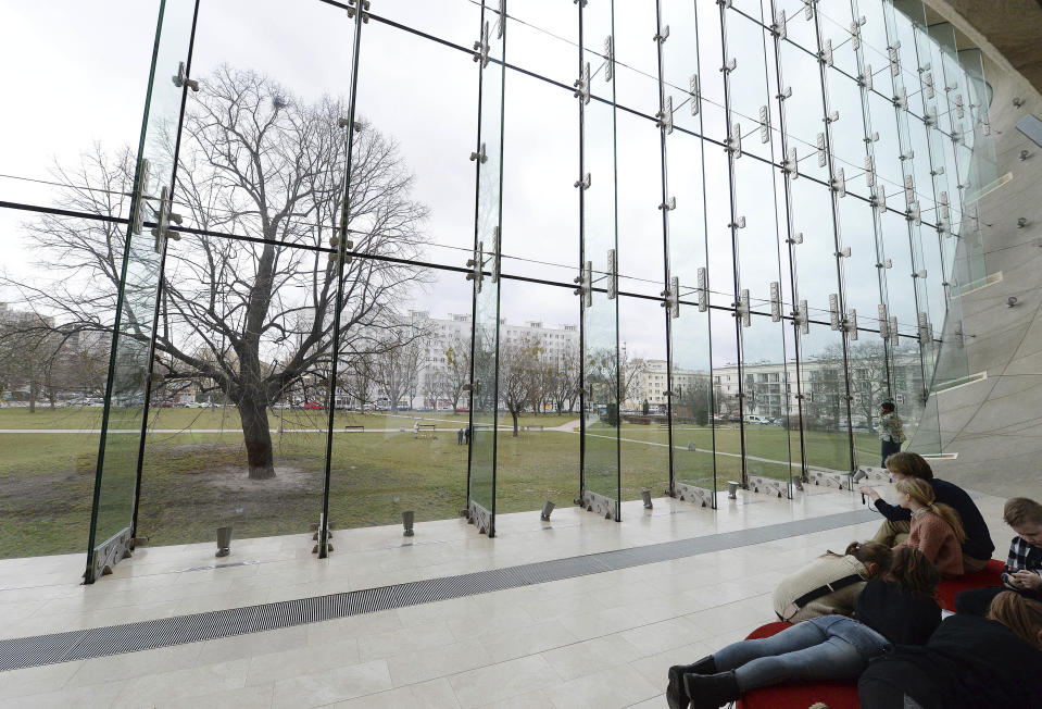 People visit the POLIN Museum of the History of Polish Jews in Warsaw, Poland, Wednesday, Feb. 12, 2020. A long stalemate over the future independence of the landmark Jewish history museum is building toward a crucial turning point after the former director — who won a competition for a second term but whom Poland's populist government refuses to reinstate — offered to renounce the job.(AP Photo/Czarek Sokolowski)