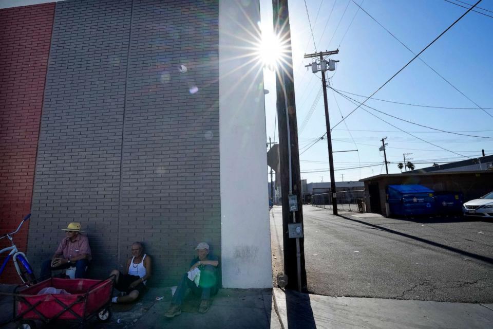 PHOTO: Men sit in the shade amid extreme heat, July 19, 2023, in Calexico, Calif. (Gregory Bull/AP)