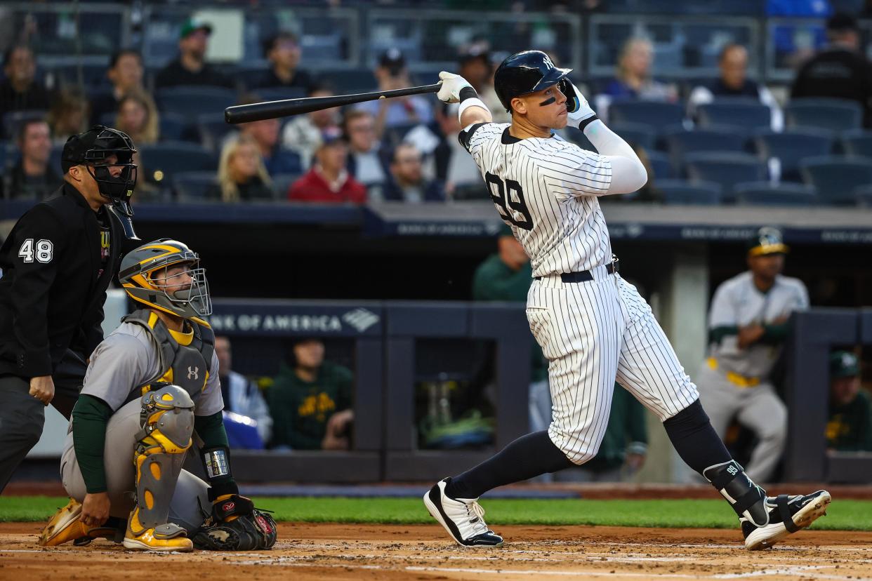 Apr 24, 2024; Bronx, New York, USA; New York Yankees center fielder Aaron Judge (99) hits a two run home run in the first inning against the Oakland Athletics at Yankee Stadium. Mandatory Credit: Wendell Cruz-USA TODAY Sports