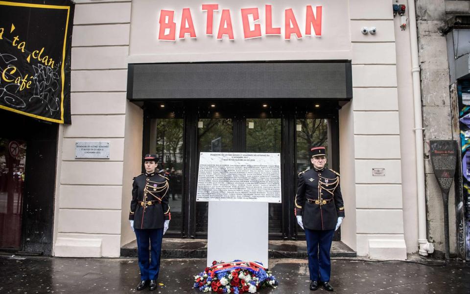 French Republican Guards stand next to a commemorative plaque at the Bataclan concert hall in Paris on November 13 - Credit: CHRISTOPHE PETIT TESSON/AFP