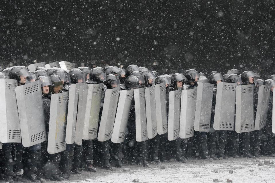 Police prepare to clash with protesters in central Kiev, Ukraine, Wednesday, Jan. 22, 2014. Several people have died in clashes between protesters and police in the Ukrainian capital Wednesday, according to medics on the site, in a development that will likely escalate Ukraine's two month-long political crisis. The mass protests in the capital of Kiev erupted after Ukrainian President Viktor Yanukovych spurned a pact with the European Union in favor of close ties with Russia, which offered him a $15 billion bailout. (AP Photo/Efrem Lukatsky)