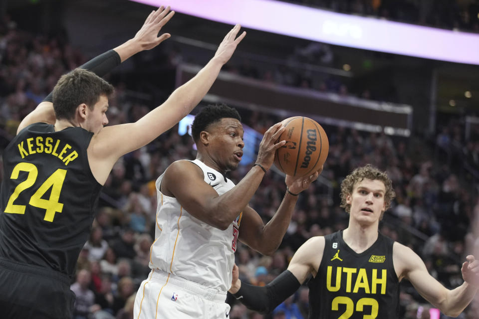 Miami Heat guard Kyle Lowry (7) passes the ball as Utah Jazz center Walker Kessler (24) and forward Lauri Markkanen (23) defend during the first half of an NBA basketball game Saturday, Dec. 31, 2022, in Salt Lake City. (AP Photo/George Frey)