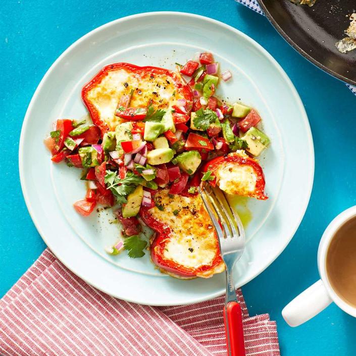 <p>Colorful bell pepper rings stand in for bread in this healthy version of egg in a hole. Cook an egg inside the peppers and top with a vibrant avocado salsa for a cheerful breakfast. <a href="https://www.eatingwell.com/recipe/269125/egg-in-a-hole-peppers-with-avocado-salsa/" rel="nofollow noopener" target="_blank" data-ylk="slk:View Recipe" class="link ">View Recipe</a></p>