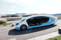 The solar-powered vehicle drives in a closed road, in Guyancourt, south of Paris, Friday Sept. 24, 2021. A group of Dutch students has reimagined van life and is hitting the road to Portugal. Just don't call their groundbreaking new solar-powered vehicle a campervan. (AP Photo/Thibault Camus)