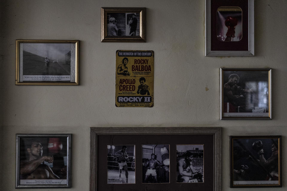 Framed photos of Muhammad Ali and a vintage movie memorabilia adorn a wall at Kiko Boxing Club in Kyiv, Ukraine, Tuesday, July 11, 2023. Ukrainian boxer Anna Lysenko trains at the gym for next year's Paris Olympics despite the unsettling sounds of explosions booming outside. (AP Photo/Jae C. Hong)