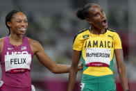 Stephenie Mcpherson, right, of Jamaica, reacts after winning a women's 400-meter semifinal as Allyson Felix, of the United States, looks on, at the 2020 Summer Olympics, Wednesday, Aug. 4, 2021, in Tokyo. (AP Photo/Petr David Josek)