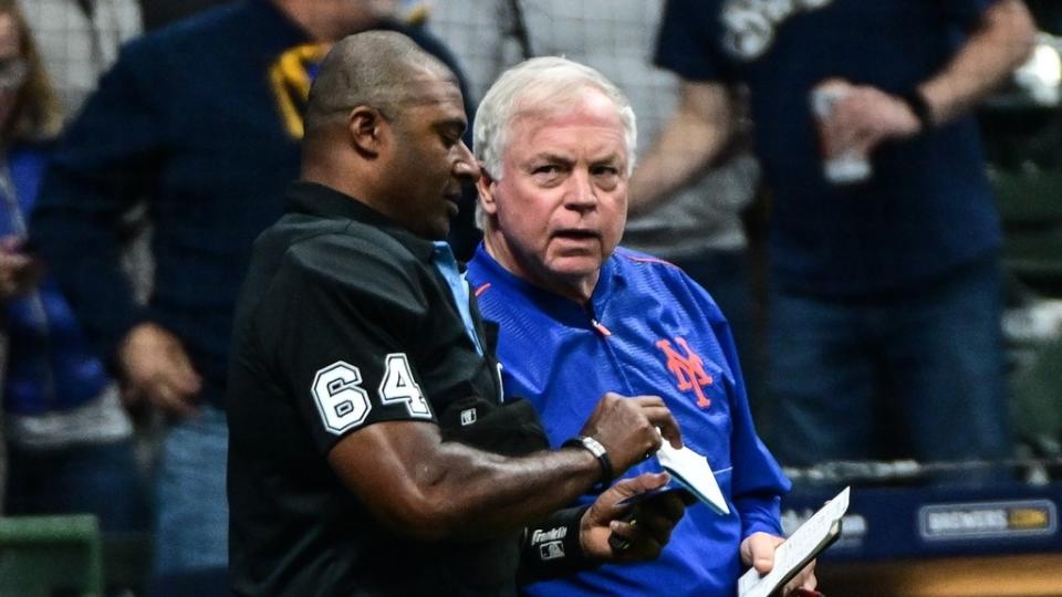 New York Mets Buck Showalter discusses a pitching change with home plate umpire Alan Porter in the seventh inning during a game against the Milwaukee Brewers.