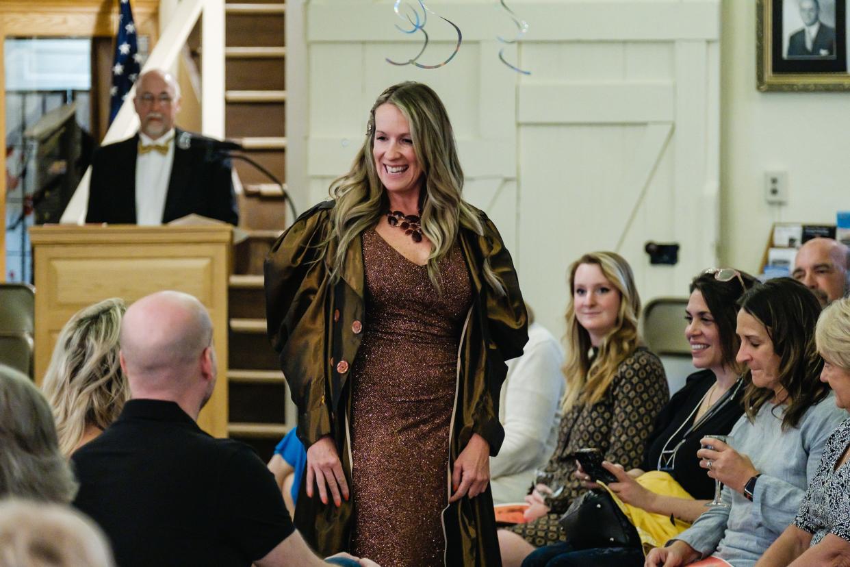 Shannon McGlothlin enters the runway as the first model at the "Sign of the Times Vintage Fashion Show" at the Reeves Museum. Fashion shows at the museum have been running for 28 years. The show, held May 8, was designed around the 12 zodiac signs. "Each elemental sign corresponded to how each person has decided to dress," museum Director Shelagh K. Pruni said. All clothing was donated by members the community.