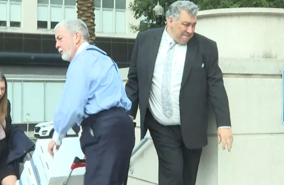 Attorney Curtis Falgatter, left, and his client Dr. Scott Hollington enter the federal courthouse for their July trial. Hollington was convicted of 19 counts of drug trafficking and obstruction of justice in his federal sex-for-drugs case.