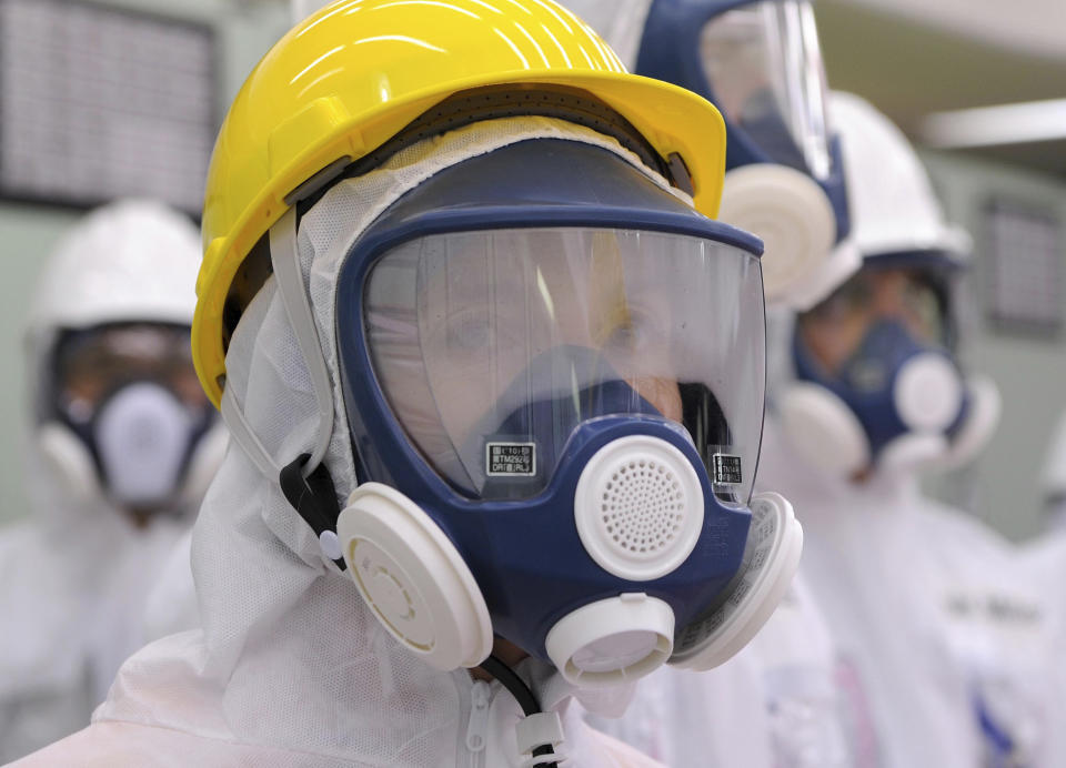 U.S. Ambassador to Japan Caroline Kennedy wearing a yellow helmet and a mask inspects the central control room for the Unit One and Unit Two reactors of the tsunami-crippled Fukushima Dai-ichi nuclear power plant, operated by Japan's Tokyo Electric Power Co. (TEPCO), in Okuma, Fukushima Prefecture, northeastern Japan, Wednesday, May 14, 2014. Kennedy toured the Fukushima Dai-ichi plant for about three hours Wednesday. (AP Photo/Toru Yamanaka, Pool)