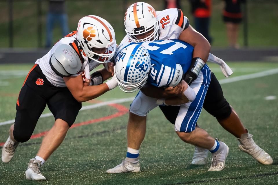Central York's Collin Glassmyer (left) and Danny Pham team up to sack Spring Grove quarterback Andrew Osmun on the Rockets' first offensive play at Papermakers Stadium on Friday, September 16, 2022.