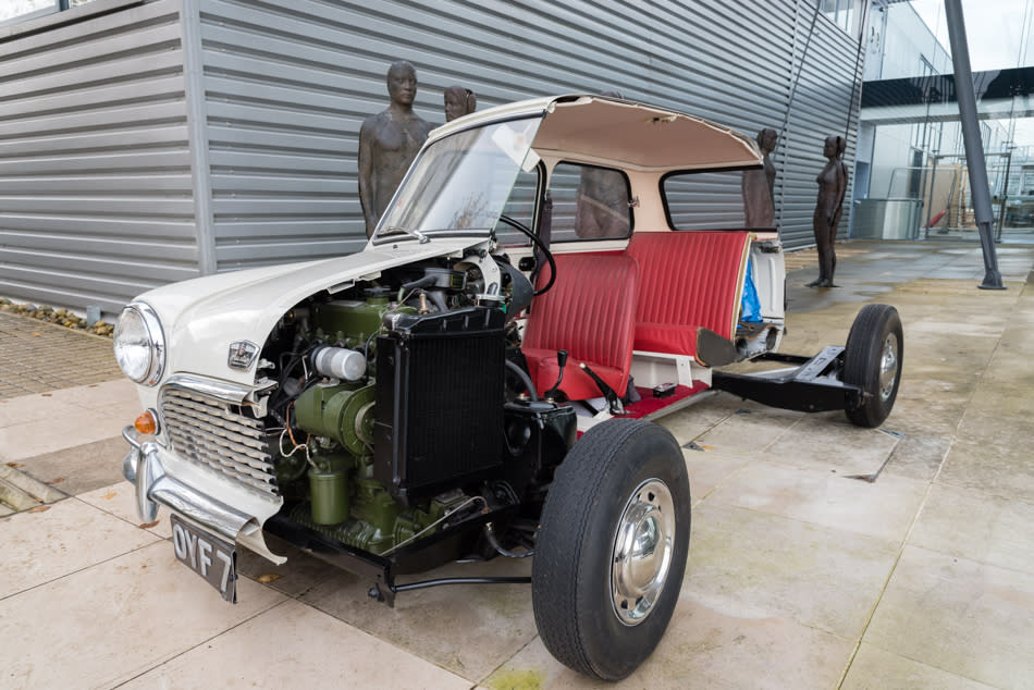 A 1961 Austin Mini – sawn in half, revealing its inner workings – greets you at the door.