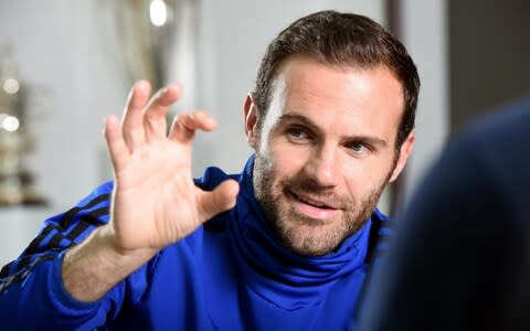 Manchester United footballer Juan Mata pictured at the Carrington training ground against a backdrop of trophies won by the club. - Credit: Asadour Guzelian