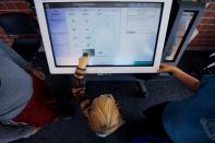 FILE PHOTO: Five year-old Donald Carmen casts his vote on a new Election Systems & Software ExpressVote XL voting machine in Hanover Township