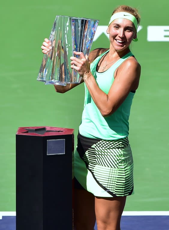 Elena Vesnina of Russia lifts the trophy after defeating compatriot Svetlana Kuznetsova in the women's singles final at the WTA Indian Wells Masters on March 19, 2017