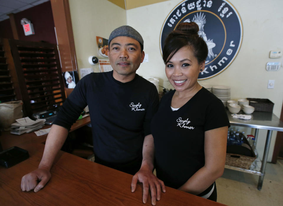 This March 14, 2014 photo shows Sambath Neang, left, and Denise Phon Ban, owners of Simply Khmer, at their Cambodian restaurant in Lowell, Mass. Simply Khmer is considered by some to offer the best _ and most authentic _ Cambodian food in the city. (AP Photo/Elise Amendola)