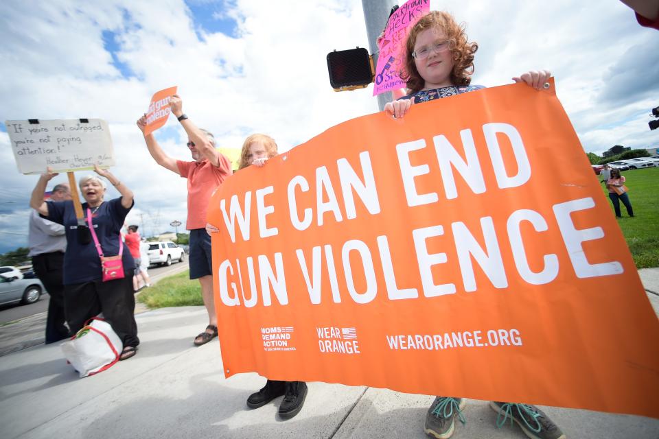 Demonstrators hold a sign reading "We Can End Gun Violence" at a demonstration against gun violence on May 27.