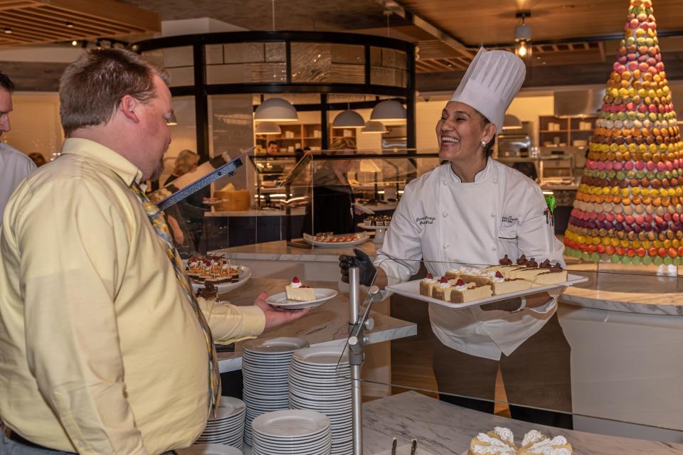 A chef at 7 Kitchens, one of the restaurants at Turning Stone Resort Casino, dishes up a platter of desserts.