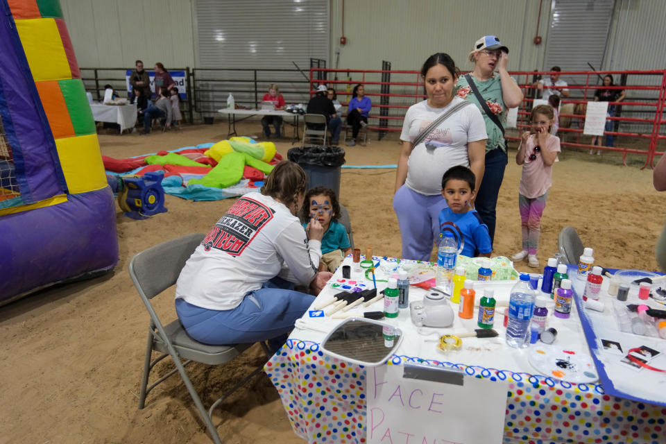 Trista Mills, co-organizer of Barks and Recreation and Associate Professor of General Veterinary Practice at Texas Tech School of Veterinary, shows off her face painting skills at Saturday's Mariposa Station in west Amarillo event.