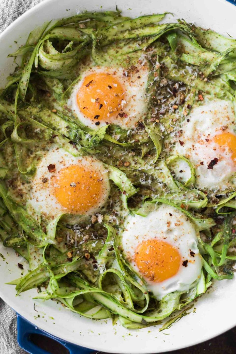 Baked eggs with shaved asparagus and pesto.