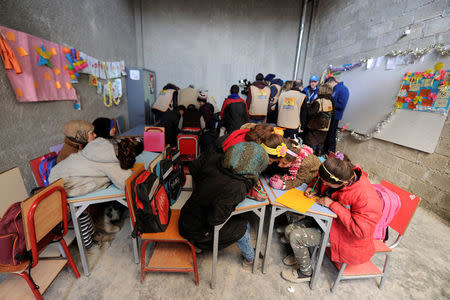 Students sit inside a classroom in Aleppo's Jibreen shelter, Syria February 1, 2017. REUTERS/Omar Sanadiki