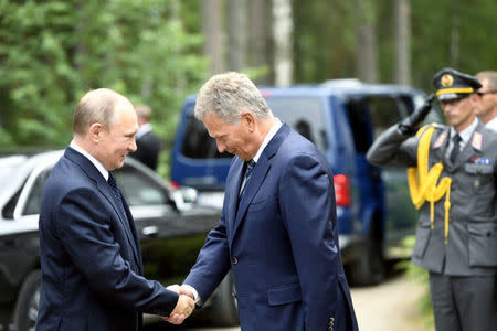 Finnish President Sauli Niinisto (R) welcomes Russian President Vladimir Putin at the Hotel Punkaharju in Savonlinna, Eastern Finland July 27, 2017. Lehtikuva/Martti Kainulainen/via REUTERS