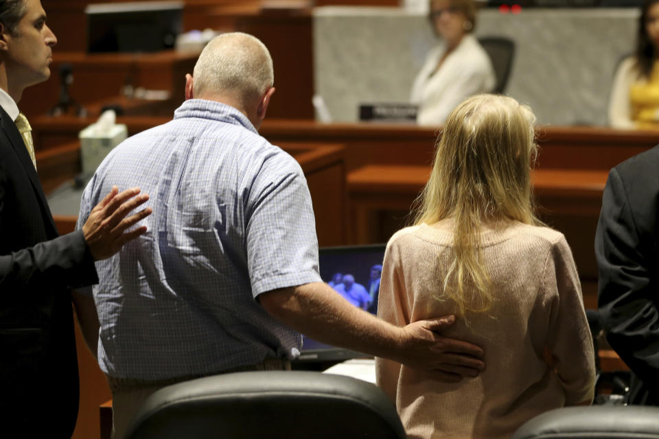 Scott Richardson, left, comforts his daughter, Brooke Skylar Richardson, after he delivered a statement during her sentencing hearing, Friday, Sept. 13, 2019, in Lebanon, Ohio. Richardson, acquitted the day before of killing her newborn but convicted of corpse abuse, was sentenced to three years' probation, was sentenced to three years' probation. (Kareem Elgazzar/The Cincinnati Enquirer via AP, Pool)