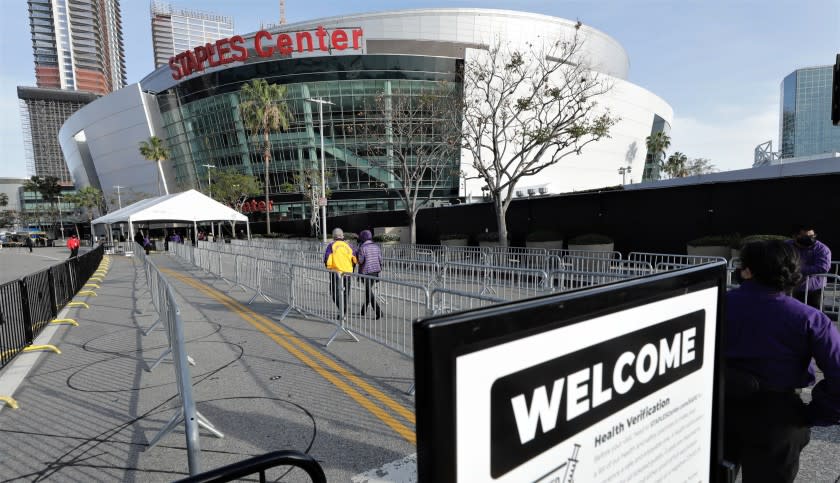 A slow trickle of fans head toward the Staples Center entrance for the Lakers-Celtics game on April 15, 2021.